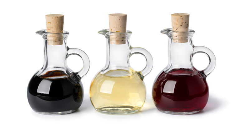 three bottles vinegar white background