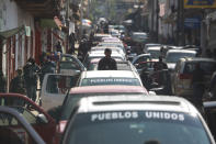 Members of the so-called self-defense group known as United Towns or Pueblos Unidos, gather for a rally in Nuevo Urecho, in the Mexican western state of Michoacan, Saturday Nov. 27, 2021. Extortion of avocado growers in western Mexico has gotten so bad that 500 vigilantes from the "self-defense" group gathered Saturday and pledged to aid police. (AP Photo/Armando Solis)