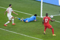 Morocco's goalkeeper Yassine Bounou, center, fails to stop an own goal by Morocco's Nayef Aguerd, not seen, as Canada's Cyle Larin and Morocco's Romain Saiss look on during the World Cup group F soccer match between Canada and Morocco at the Al Thumama Stadium in Doha , Qatar, Thursday, Dec. 1, 2022. (AP Photo/Alessandra Tarantino)