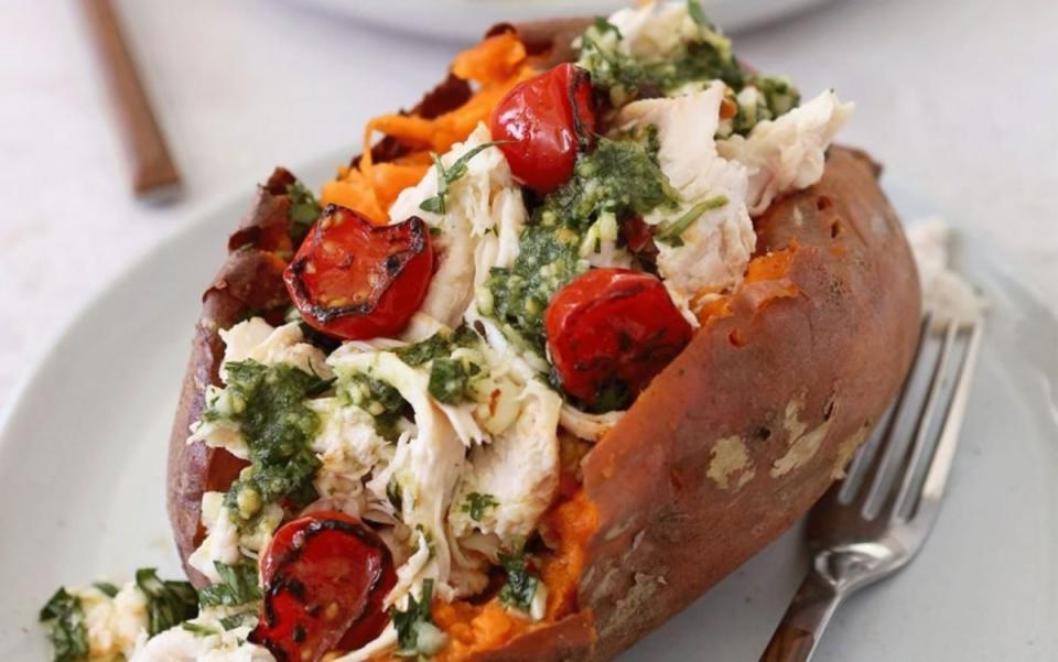 <p>In this Chicken and Pesto-Stuffed Sweet Potatoes recipe from <em>The Whole Smiths Real Food Every Day</em> by Michelle Smith, bright and garlicky <a href="/842749/communitytable/lemon-pesto-chicken/" data-ylk="slk:pesto;elm:context_link;itc:0;sec:content-canvas" class="link ">pesto</a> partners deliciously with baked sweet potatoes and <a href="/1009145/parade/shredded-chicken-recipes/" data-ylk="slk:shredded chicken;elm:context_link;itc:0;sec:content-canvas" class="link ">shredded chicken</a>. Get the recipe <a href="/1097336/parade/chicken-and-pesto-stuffed-sweet-potatoes-are-a-delicious-paleo-dinner/" data-ylk="slk:HERE;elm:context_link;itc:0;sec:content-canvas" class="link "><strong>HERE</strong></a>.</p>