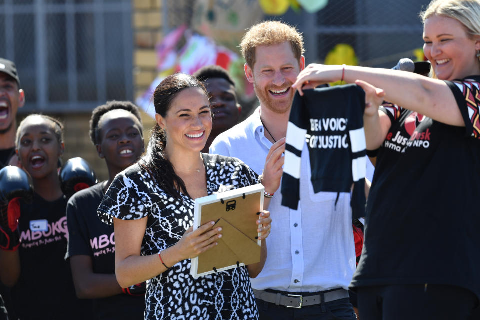 The Duke and Duchess of Sussex are presented with a gift for son Archie as they visit the Nyanga Township in Cape Town, South Africa, during the first day of their tour of Africa. (Photo by Dominic Lipinski/PA Images via Getty Images)