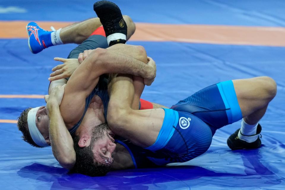 Zaurbek Sidakov of Russia, center, and Lansing native Kyle Dake of U.S. compete in their men's freestyle 74 kg wrestling final match during the Wrestling World Championships in Belgrade, Serbia, on Sept. 18, 2023.