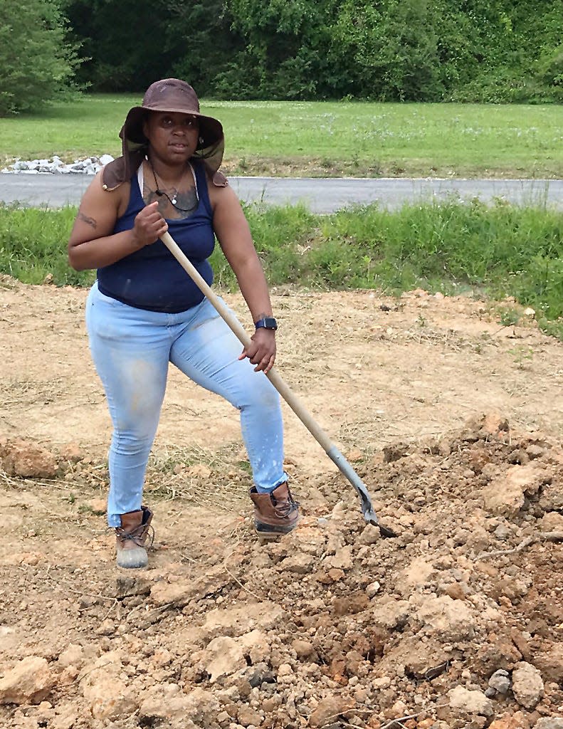 Gadsden-Etowah Habitat for Humanity homeowner Ebony Pace is shown contributing some of the "sweat equity" required for her house and others'.