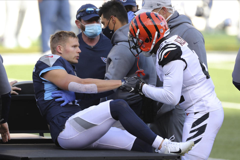 Cincinnati Bengals' Mackensie Alexander (21) talks with Tennessee Titans' Adam Humphries (10) after Humphries was injured on a play during the first half of an NFL football game, Sunday, Nov. 1, 2020, in Cincinnati. (AP Photo/Jay LaPrete)