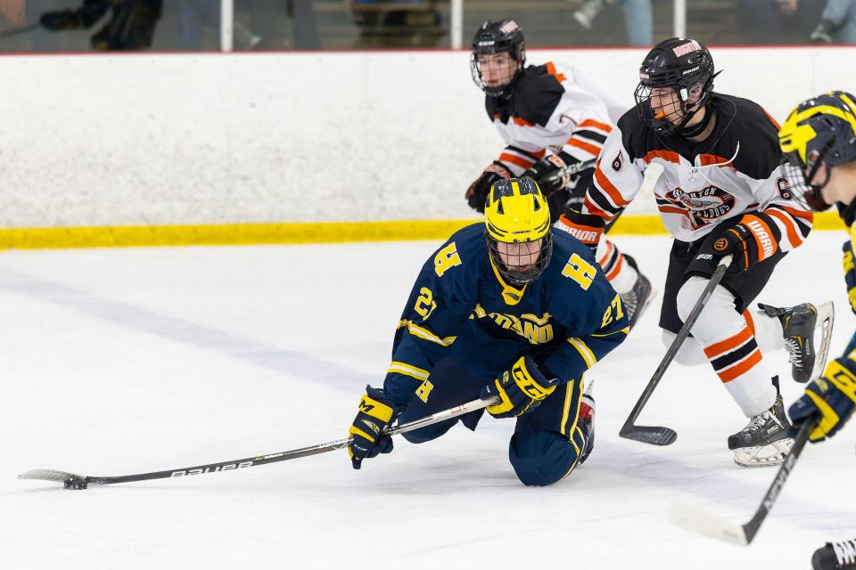 Hartland's Jack Paweski flips a pass off as Brighton's Ian Samp sends him to the ice during the Eagles' 2-1 win on Saturday, Jan. 15, 2022 at Kensington Valley Ice House.