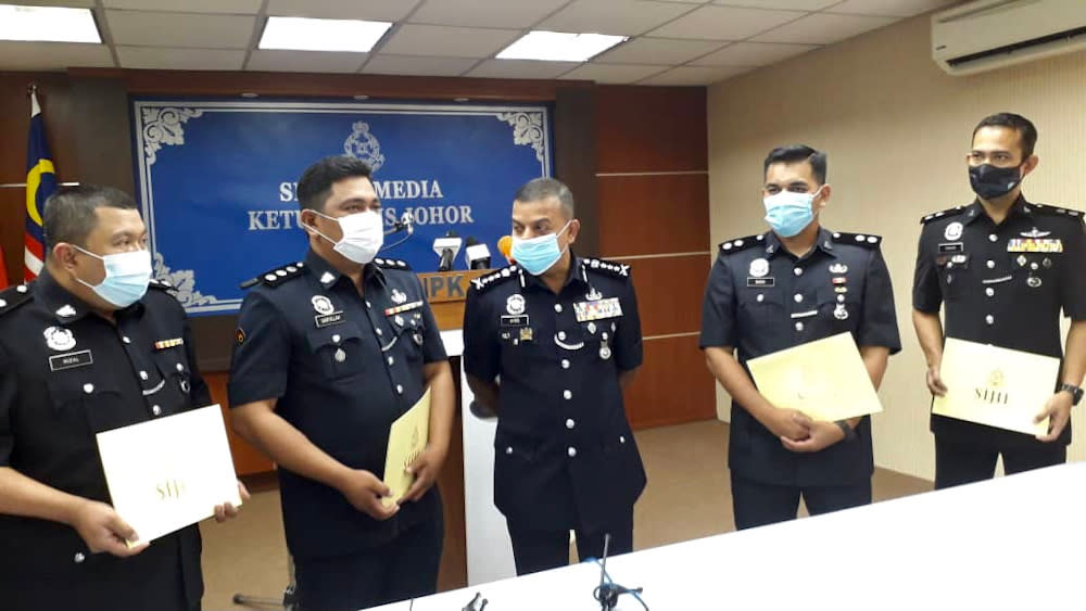 Johor police chief Datuk Ayob Khan Mydin Pitchay (centre) after giving out integrity commendation letters to police officers at the Johor police contingent headquarters in Johor Baru December 3, 2020. — Picture by Ben Tan