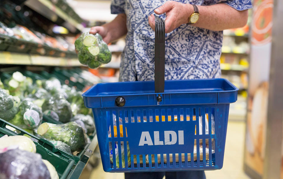 Person shopping at Aldi with a shopping basket