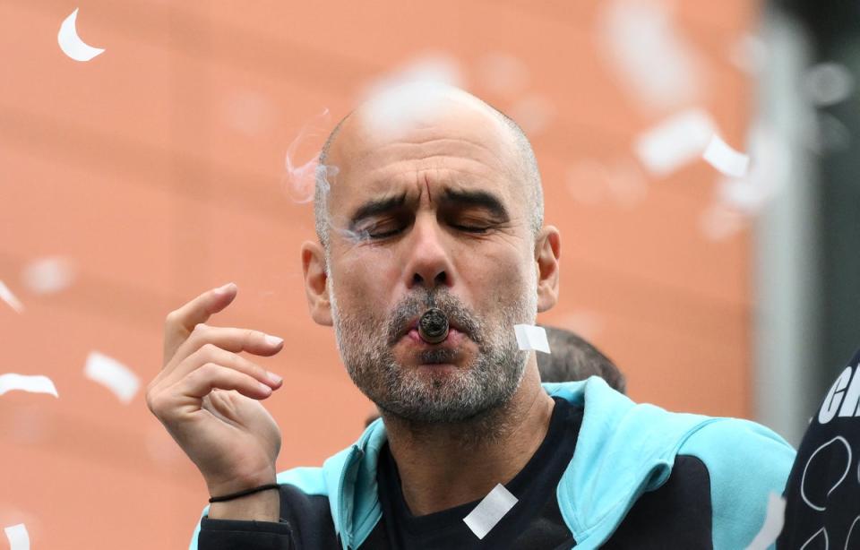 Pep Guardiola treated himself to a celebratory cigar during Manchester City’s trophy parade (Getty Images)
