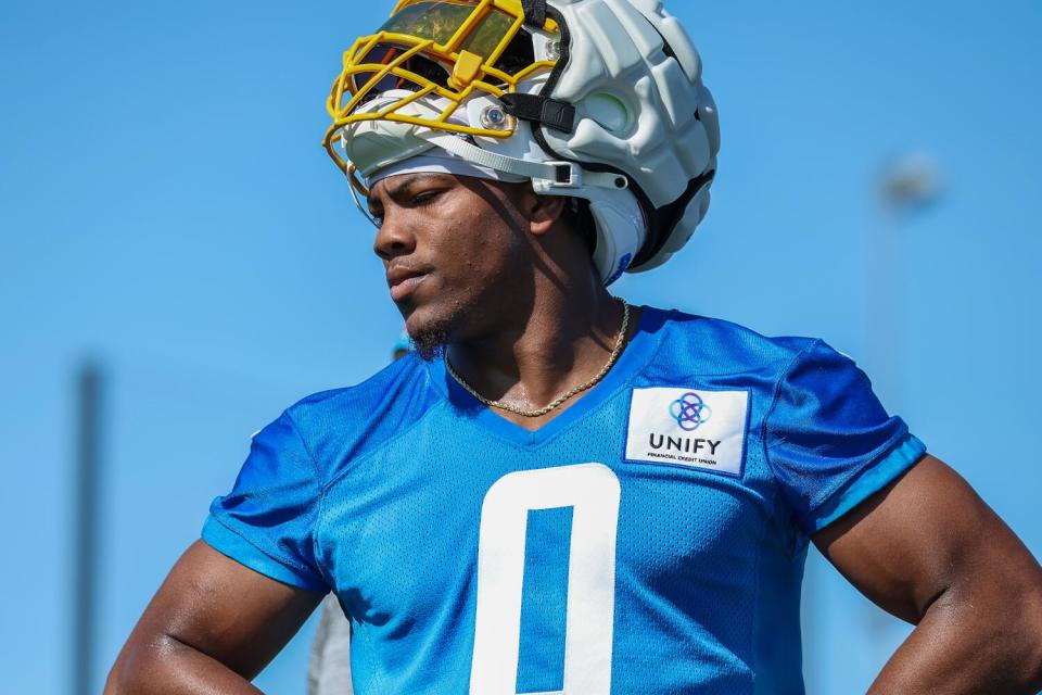 Daiyan Henley stands with his helmet on at practice.