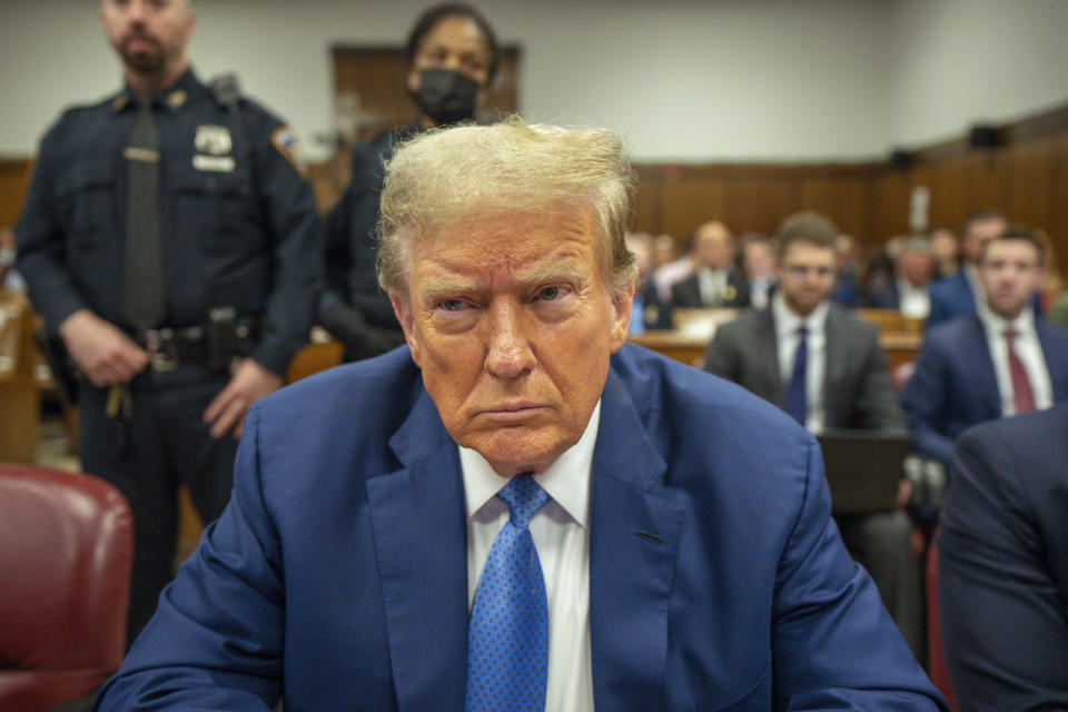 Former President Donald Trump sits in court.