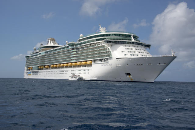  The Royal Caribbean Freedom of the Seas, which carries 4,515 passengers and 1,360 crew, and the Celebrity Reflection, which carries 3,609 passengers and 1271 crew, in the harbor of George Town, Grand Cayman in the Cayman Islands on Tuesday, December 20, 2016. The smaller boat is a tender to ferry passengers back and forth to the island. Credit: Ron Sachs / CNP *** Please Use Credit from Credit Field *** 