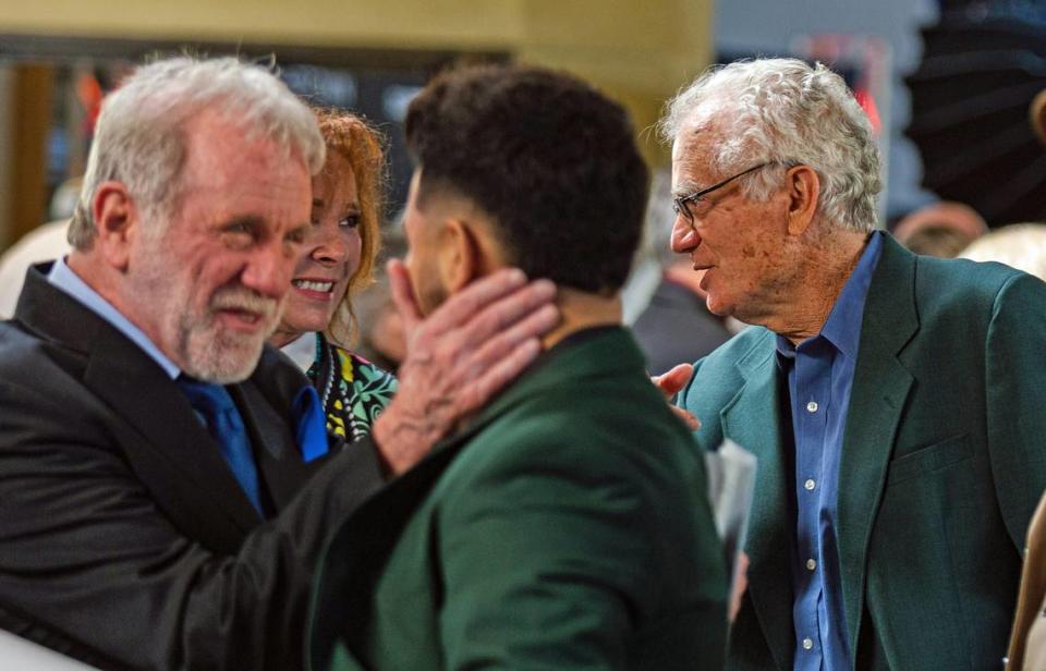 Veteran actor John Henry Richardson, left, lead actor in the not-yet-released film written, cast and produced in Cambria, greets one of his director producers, Julian Mercado, while screen writer Steve Brody chats with folk singer/songwriter Juni Fisher at a gala that preceded the Jan. 13, 2024, sneak peek of the movie “Hidden Creek.”