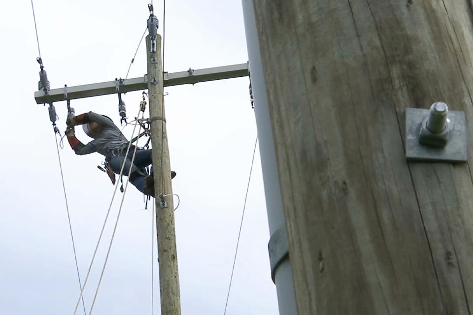 In this Thursday, March 21, 2019, photo, 120 feet off the ground, Jordan Demartino hangs from a training pole near Duke Energy's field office in Simpsonville, S.C. (AP Photo/Sarah Blake Morgan)