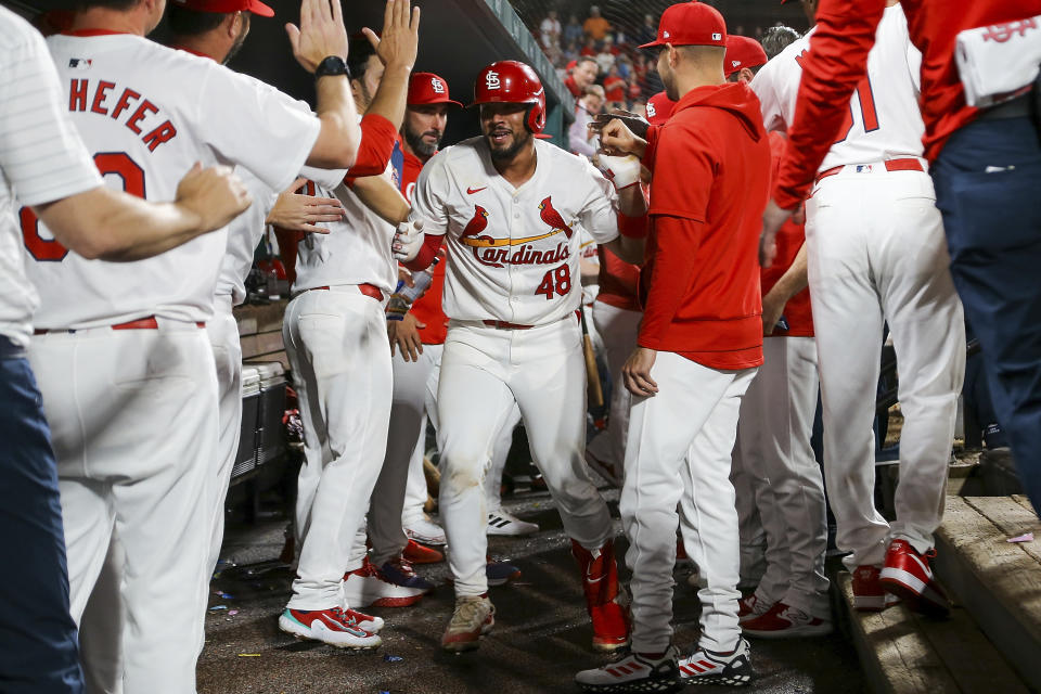 St. Louis Cardinals' Iván Herrera is congratulated by teammates after hitting a solo home run during the seventh inning of a baseball game against the Philadelphia Phillies Monday, April 8, 2024, in St. Louis. (AP Photo/Scott Kane)