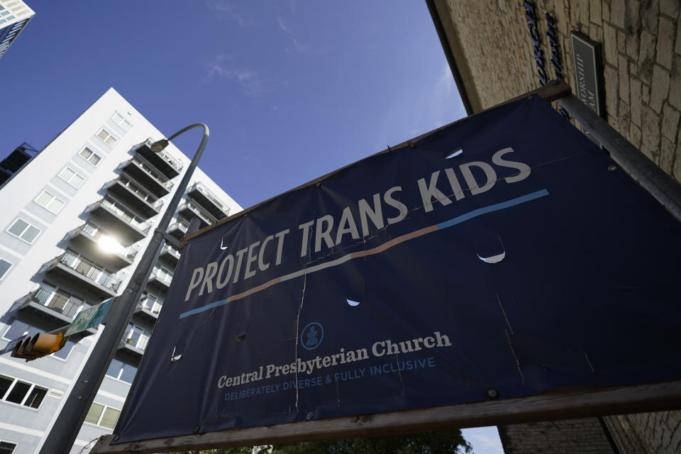 A sign encouraging the protection of transgender children stands at Central Presbyterian Church near the Texas Capitol, Tuesday, Aug. 15, 2023, in Austin, Texas. Waiting lists for gender-affirming health care are growing in states that declared themselves refuges for transgender people as bans for such care for minors take effect around the country. Texas, one of the largest states, has a ban that's set to take effect Sept. 1. (AP Photo/Eric Gay)