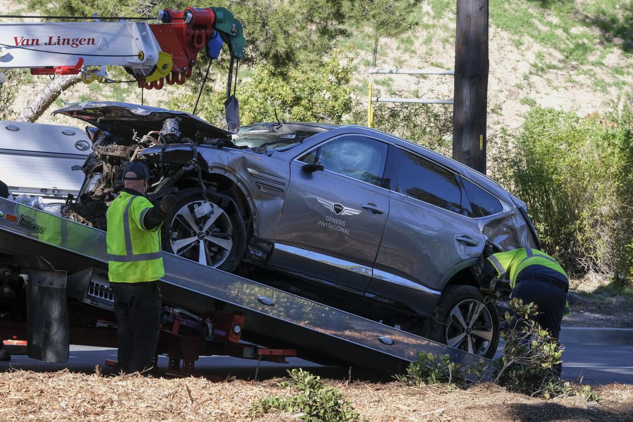 A damaged vehicle is placed on a flatbed truck following a rollover accident involving golfer Tiger Woods, Tuesday, Feb. 23, 2021, in the Rancho Palos Verdes suburb of Los Angeles.