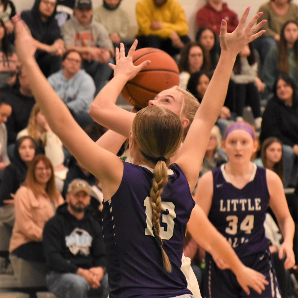 Herkimer Magician Aubrey Lewis attempts a shot with Makaylah Mowers (13) defending for Little Falls and Alexis Kress looking on during Saturday's Section III playoff game.