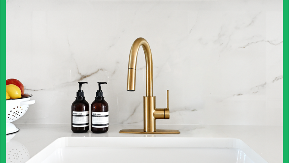 a sink with bottles and a faucet