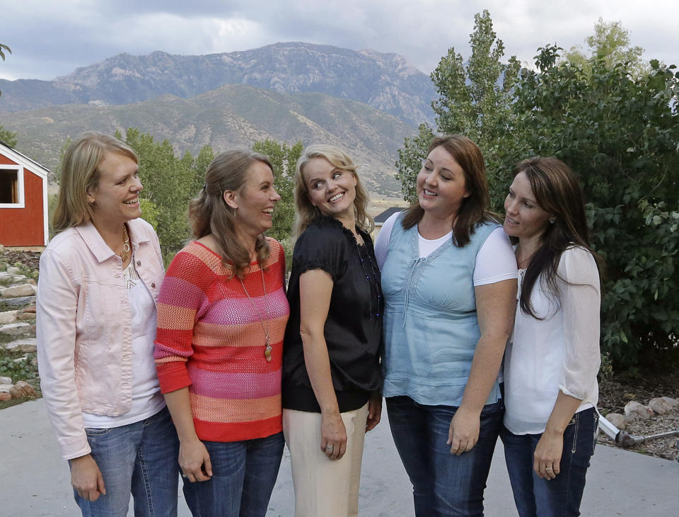 FILE - In this Sept. 11, 2013, file photo, Brady Williams five wives, from left to right, Robyn, Nonie, Rhonda, Rosemary and Paulie, pose for a photograph outside of their home in a polygamous community outside Salt Lake City. The newest Utah polygamous family featured in a reality TV show says sharing their story with a wide audience has been liberating. Brady Williams and his five wives were a bit apprehensive ahead of the airing of a pilot episode in September, but they said this week an interview with The Associated Press that it felt liberating to be open about who they are and what they believe. (AP Photo/Rick Bowmer, File)