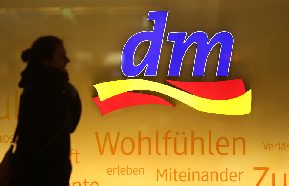 BERLIN, GERMANY - JANUARY 08:  A woman walks past a store of German drugstore retailer DM at Alexanderplatz on January 8, 2018 in Berlin, Germany. Much of the German consumer goods and foodstuffs economy is dominated by nationwide chains.  (Photo by Sean Gallup/Getty Images)