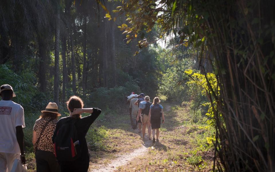 Tourists walk along a path in the Bissagos Archipelago