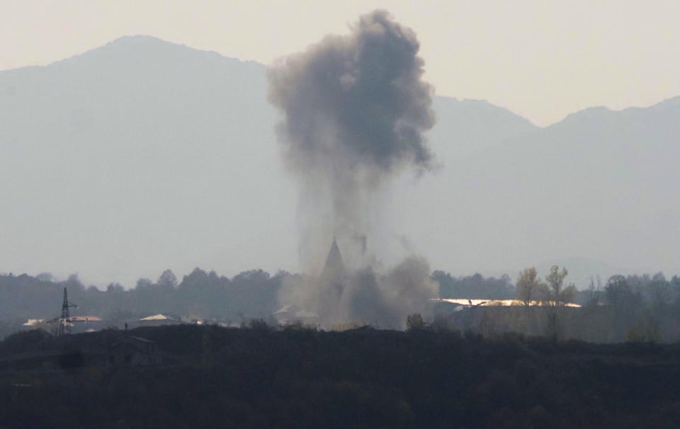 Smoke rises during shelling by Azerbaijan's artillery near Stepanakert, the separatist region of Nagorno-Karabakh, Wednesday, Oct. 28, 2020. Nagorno-Karabakh officials said Azerbaijani forces hit Stepanakert, the region's capital, and the nearby town of Shushi with the Smerch long-range multiple rocket systems, killing one civilian and wounding two more. (AP Photo)