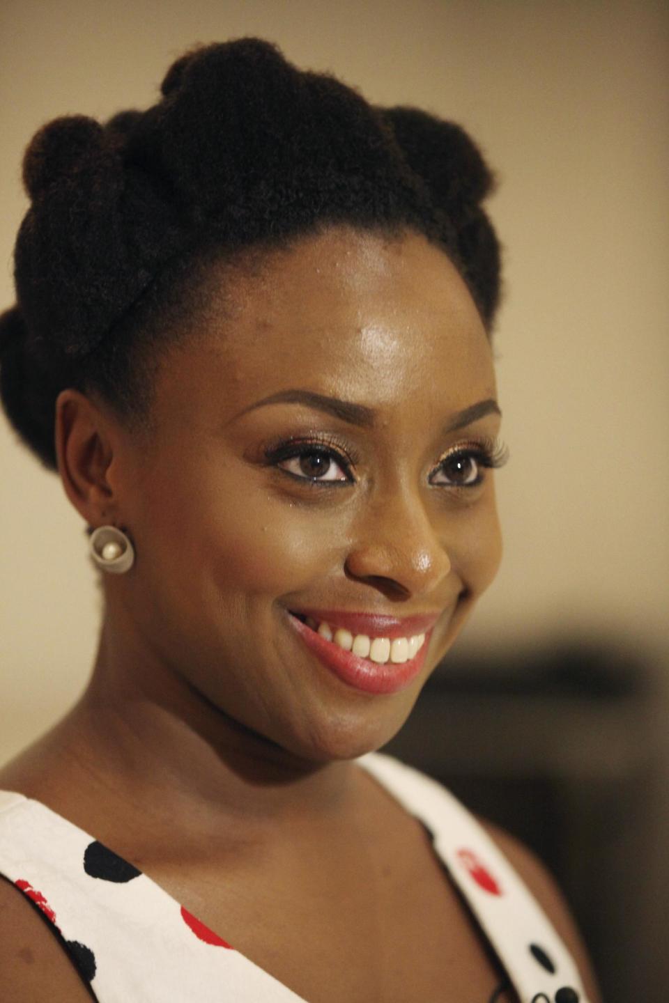 FILE- In this April. 27, 2013 file photo, Chimamanda Ngozi Adichie, speaks to Associated Press during an interview in Lagos, Nigeria. The latest novel by the acclaimed Nigerian author Adichie, “Americanah,” has won the National Book Critics Circle prize for fiction announced on Thursday, March 13, 2014. The NBCC was established in 1974 and has around 600 members. (AP Photo/Sunday Alamba, file)