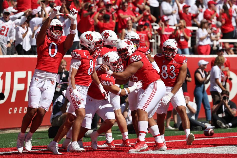 Utah's defense celebrates a pick six against UCLA.