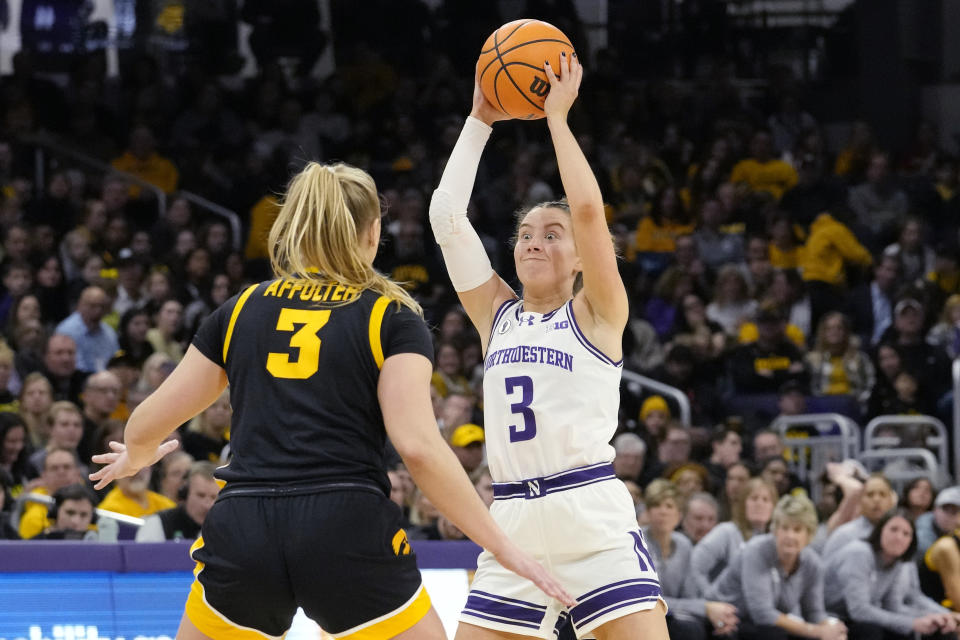 Northwestern guard Maggie Pina, right, looks to pass against Iowa guard Sydney Affolter during the second half of an NCAA college basketball game in Evanston, Ill., Wednesday, Jan. 31, 2024. Iowa won 110-74. (AP Photo/Nam Y. Huh)