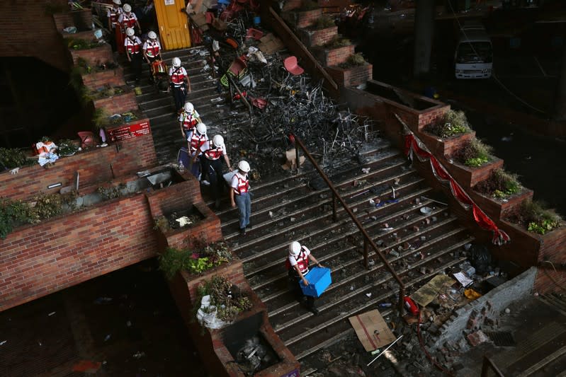 Medical personnel leave the Hong Kong Polytechnic University (PolyU) following a news conference where university staff announced they had not found any protesters left on campus, in Hong Kong, China