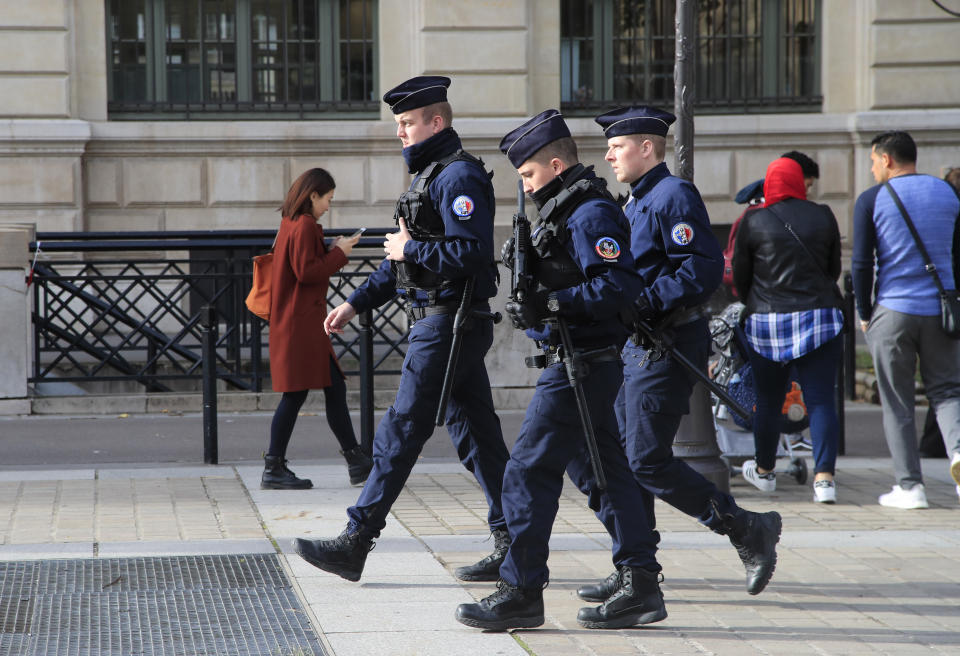 Police officers patrol outside the police headquarters in Paris, Friday, Oct. 4, 2019. The French government says there is nothing to suggest the police employee who stabbed four colleagues to death at Paris police headquarters yesterday was radicalized. (AP Photo/Michel Euler)