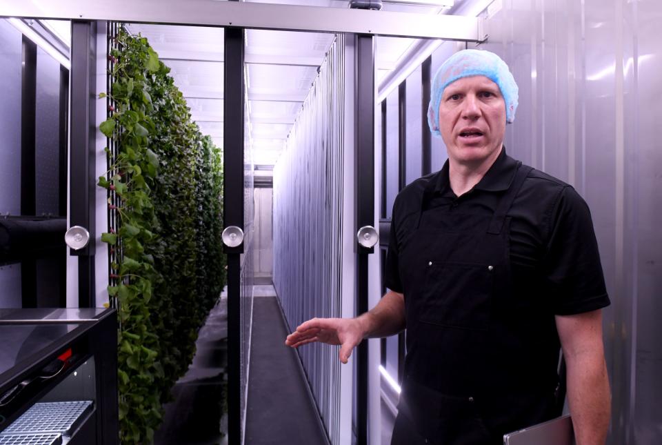 Paul Smith, owner of Next Door Harvest vertical freight farm, discusses his new business inside a crop growing container in Perry Township. Smith grows lettuce, beets, carrots, herbs and more items inside the 320-square-foot space.