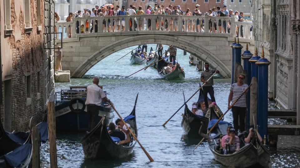 Gondoliers ride slowly near St. Mark's Square due to too much traffic. - Stefano Mazzola/Getty Images