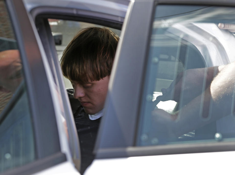 Charleston, S.C., shooting suspect Dylann Storm Roof sits inside a police car as he is escorted from the Sheby Police Department  in Shelby, N.C., Thursday, June 18, 2015. (AP Photo/Chuck Burton)