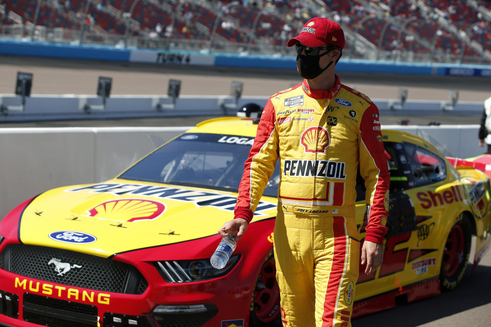 Joey Logano walks along pit road prior to a NASCAR Cup Series auto race at Phoenix Raceway, Sunday, March 14, 2021, in Avondale, Ariz. (AP Photo/Ralph Freso)