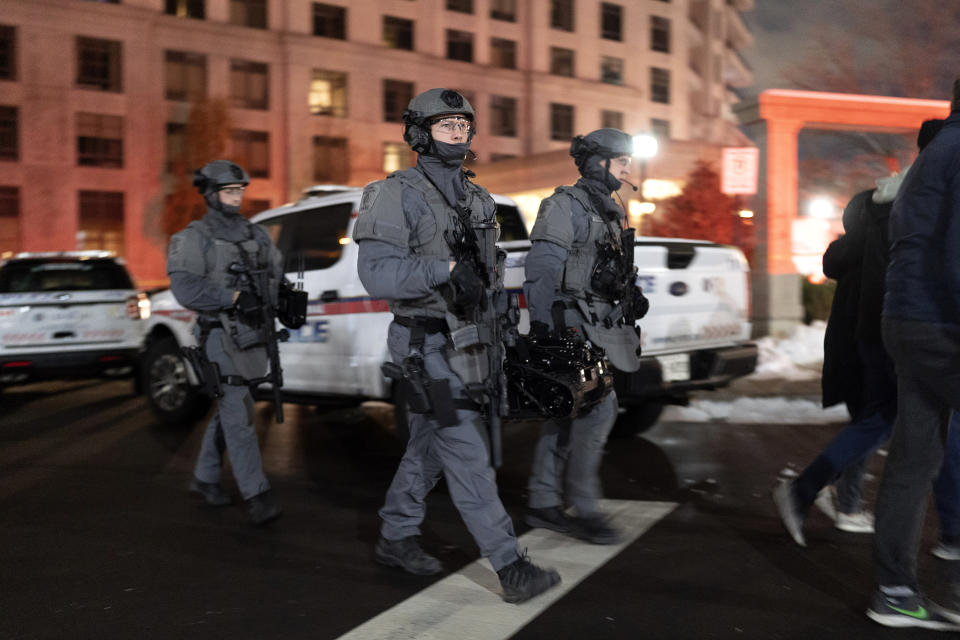 York Regional Police tactical officers work the scene of a fatal shooting in Vaughan, Ontario Sunday, Dec. 18, 2022. Authorities said multiple people were shot and killed in a condominium unit in the Toronto suburb and the gunman was killed by police. (Arlyn McAdorey/The Canadian Press via AP)