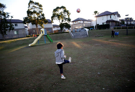 Naohito Hirose kicks a ball to her mother Mariko Hirose at a park in Higashinohara district in Inzai, Chiba Prefecture, Japan, November 1, 2018. REUTERS/Kim Kyung-Hoon