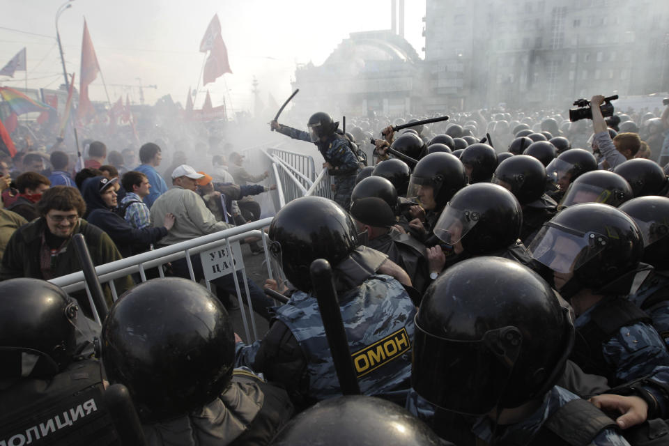 FILE - Russian riot police disperse opposition protesters in downtown Moscow on Sunday, May 6, 2012. Riot police in Moscow have begun arresting protesters who were trying to reach the Kremlin in a demonstration on the eve of Vladimir Putin's inauguration as president. Most Russian opposition figures are either in prison at home or are in exile abroad. But they vow that they will still put up a fight against President Vladimir Putin as he seeks yet another term in office in an election scheduled for March. (AP Photo/Sergey Ponomarev, File)