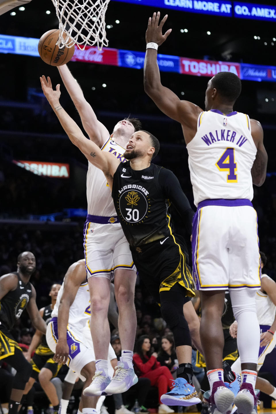 Golden State Warriors' Stephen Curry (30) gets his shot blocked by Los Angeles Lakers' Austin Reaves (15) during the second half of an NBA basketball game Sunday, March 5, 2023, in Los Angeles. (AP Photo/Jae C. Hong)