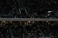 Spectators watch Serbia's Novak Djokovic playing Spain's Rafael Nadal during their quarterfinal match of the French Open tennis tournament at the Roland Garros stadium Tuesday, May 31, 2022 in Paris. (AP Photo/Thibault Camus)