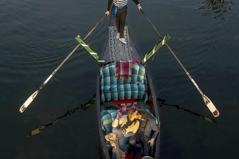 A couple takes a romantic Valentine's Day weekend gondola cruise.