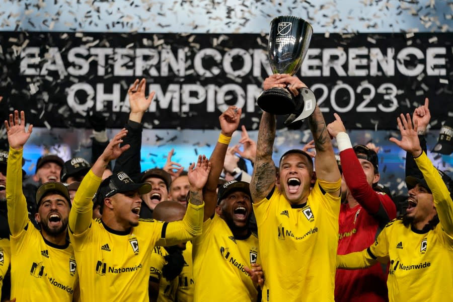 Columbus Crew forward Christian Ramirez (17) holds trophy as he celebrates with teammates after an MLS Eastern Conference Final soccer match against FC Cincinnati, Saturday, Dec. 2, 2023, in Cincinnati. Columbus won 3-2 in overtime. (AP Photo/Carolyn Kaster)