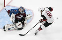 Arizona Coyotes' Taylor Hall (91) is stopped by Colorado Avalanche goalie Philipp Grubauer (31) during the third period of an NHL hockey Stanley Cup first-round playoff series, Wednesday, Aug. 12, 2020, in Edmonton, Alberta. (Jason Franson/The Canadian Press via AP)