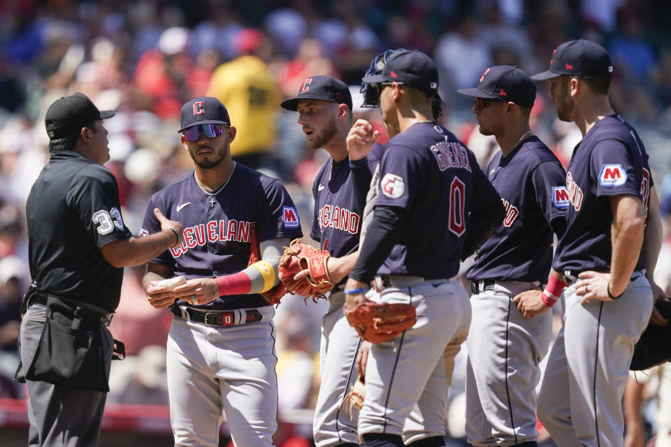 Cleveland Guardians starting pitcher Tanner Bibee, third from left, argues with an umpire, left, after Los Angeles Angels' Kyren Paris (not shown) advanced to third on a balk call during the third inning of a baseball game, Sunday, Sept. 10, 2023, in Anaheim, Calif. (AP Photo/Ryan Sun)