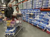 Larry and Sue Lick buy toilet paper, kitchen essentials and coffee at a Costco store in suburban Eagan, Minn., on Feb. 21, 2023, ahead of a winter storm. They also rescheduled medical appointments and a family gathering, just to stay off the roads. “It’s not so much our driving, but you’ve got to worry about everybody else driving, with so many accidents caused by people that don’t know the winter driving,” said Larry, 77. (AP Photo/Trisha Ahmed)