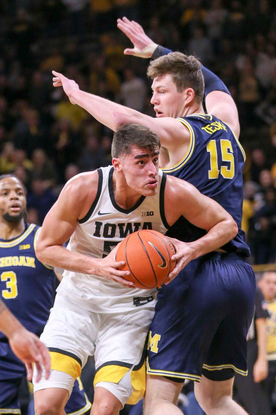 Iowa center Luka Garza drives around Michigan center Jon Teske during the first half Jan. 17, 2020 in Iowa City, Iowa.