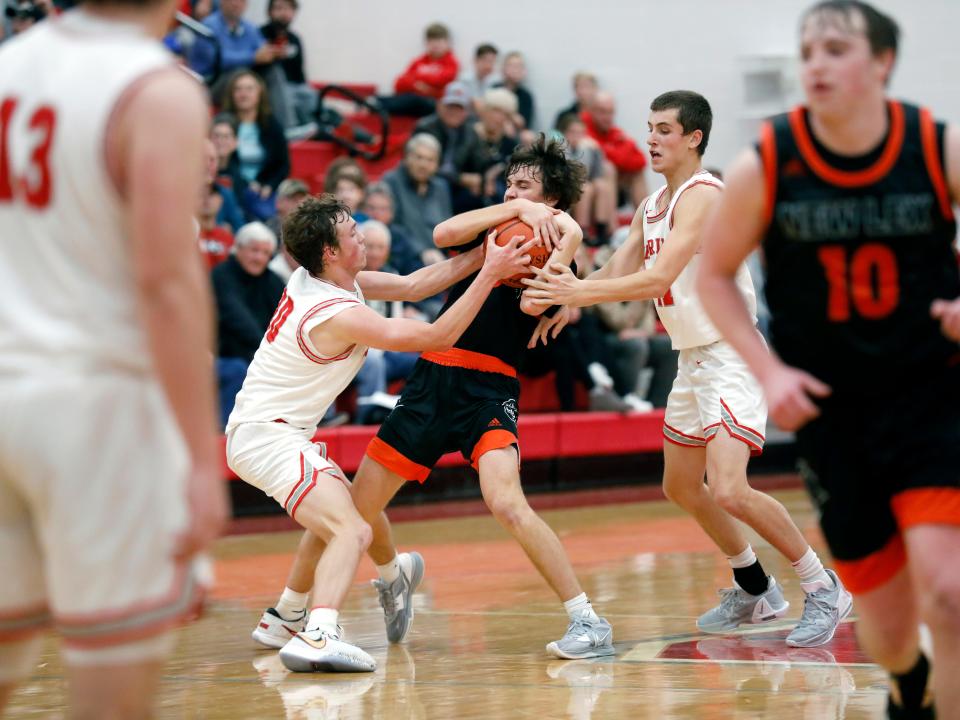 Isaiah Stephens tries to fend off the active hands of Reed Coconis, left, and Blake Turnes during visiting New Lexington's 57-34 win against Sheridan on Tuesday night in a Muskingum Valley League crossover game at Glen Hursey Gymnasium. Stephens scored a game-high 24 points as the Panthers improved to 3-1 overall.