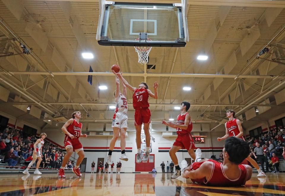 Frontier's Drew Turner (23) shoots over Keaton Miller of Twin Lakes during Tuesday's basketball game at Brookston Historic Gymnasium. The arena, built in 1952, is still used for some games by the Falcons.