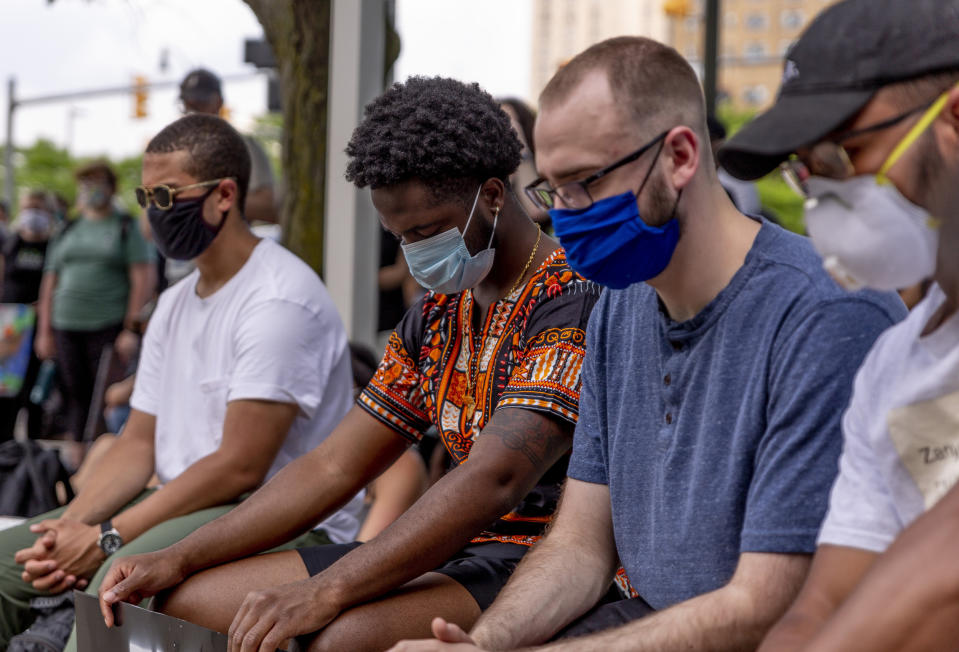 Demonstrators lower their heads for a moment of silence for victims of police brutality on June 4, 2020 in Detroit. (Sylvia Jarrus / for NBC News)