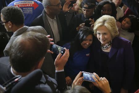 U.S. Democratic presidential candidate Hillary Clinton poses for a photograph with audience members during a campaign rally with labor unions at Faneuil Hall in Boston, Massachusetts November 29, 2015. REUTERS/Brian Snyder